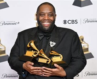 Killer Mike holds his awards at the Grammys